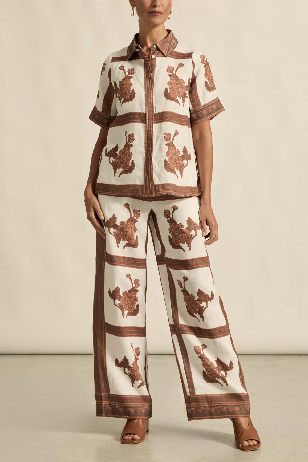 Person wearing a patterned outfit with a neutral background