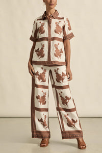 Person wearing a patterned outfit with a neutral background