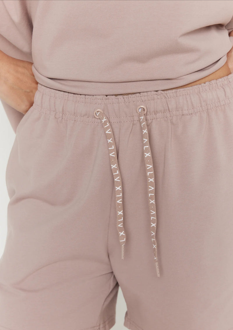 Mauve shorts with drawstring and brand logo on a white background