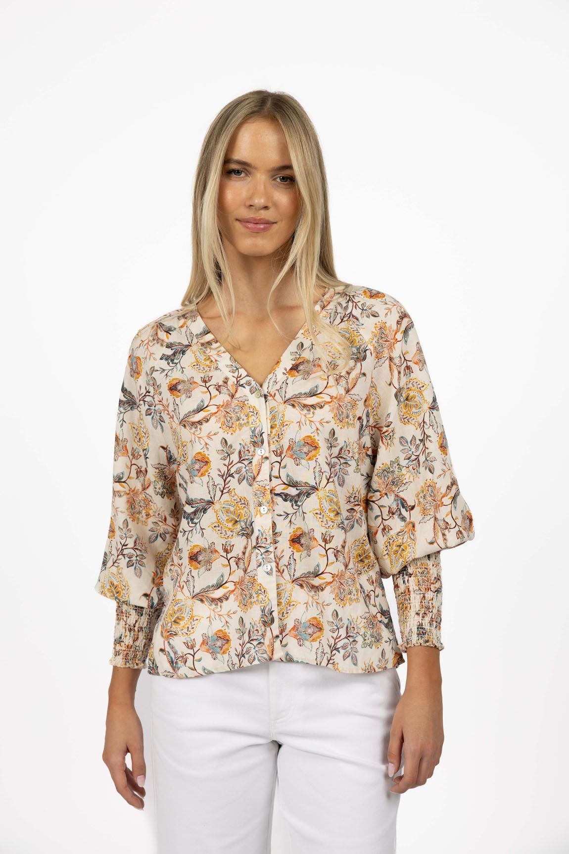 Woman wearing a floral blouse with a white background