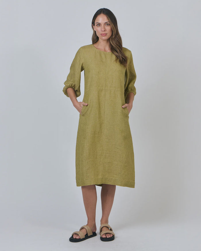 Woman wearing a green dress against a white background