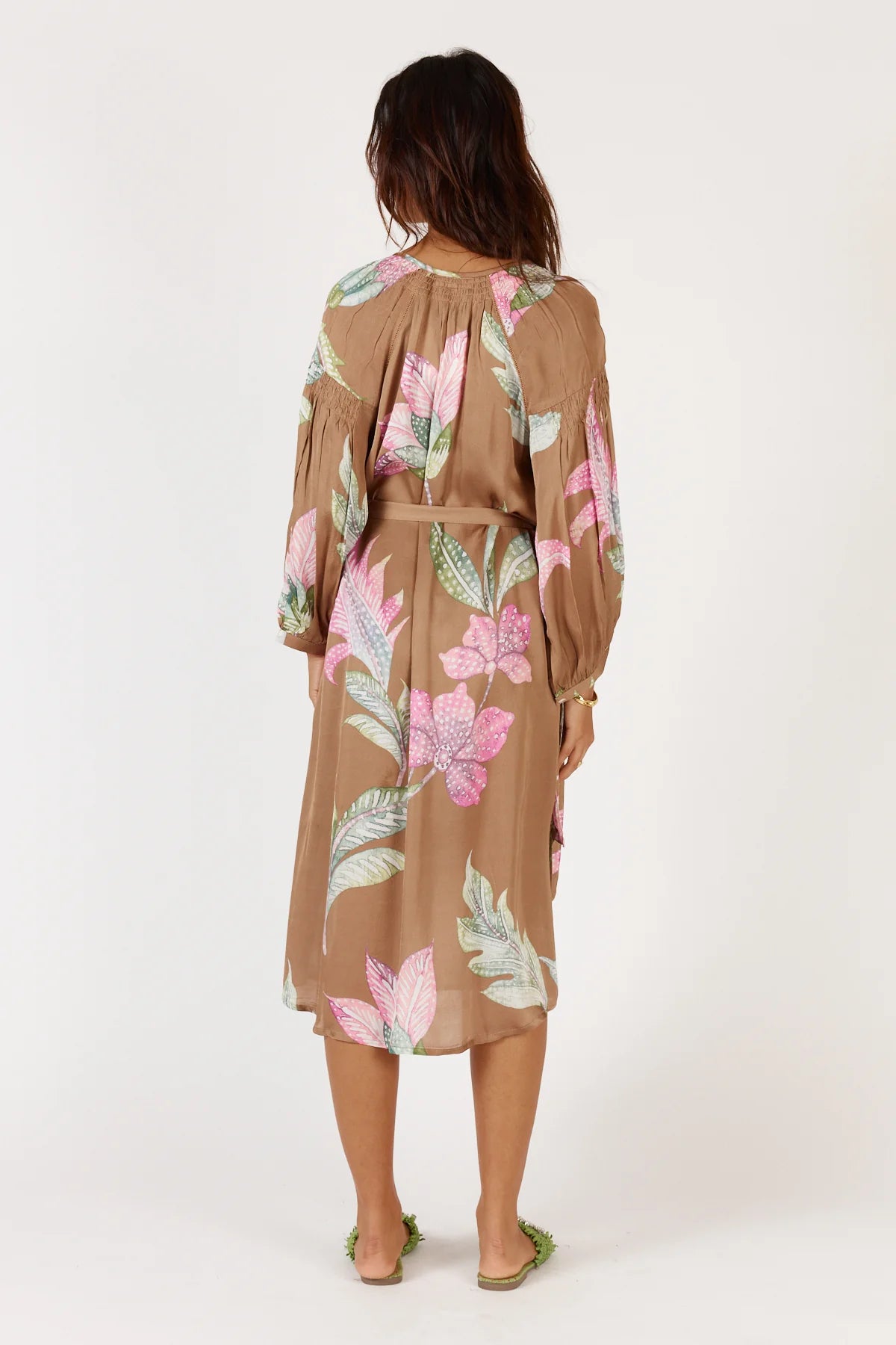 Woman wearing a floral dress with a white background
