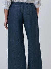 Dark blue wide-leg pants worn by a person on a plain background