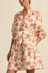 Woman wearing a floral dress on a beige background