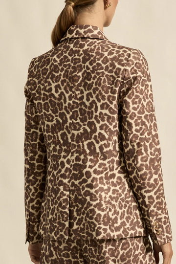 Person wearing a leopard print outfit with a neutral background