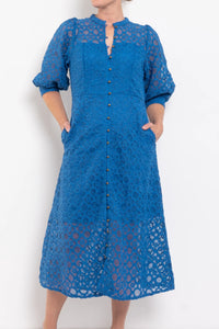 Blue lace dress with a white background